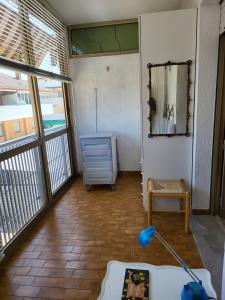 a living room with a dresser and a mirror at Monolocale a Grado in Grado +4 photos