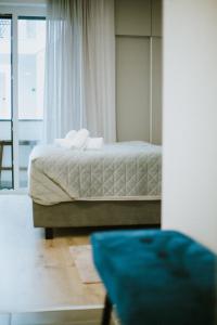 מיטה או מיטות בחדר ב-Elisabeth Downtown Suites