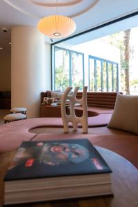 a bedroom with a book and a chair on a bed at Pacha Hotel in Ibiza Town