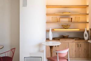 a room with a table and chairs and shelves at Pacha Hotel in Ibiza Town
