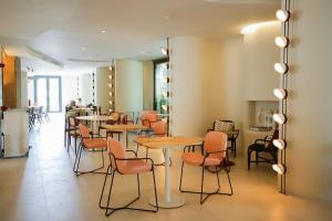 a restaurant with tables and chairs in a room at Pacha Hotel in Ibiza Town