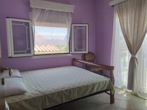 Postel nebo postele na pokoji v ubytování Villa Mitselo Apartments