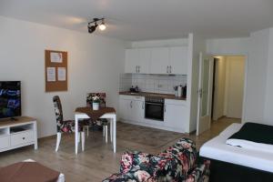ein kleines Wohnzimmer mit einem Sofa und einer Küche in der Unterkunft City-Appartement 12.2. in Zwickau