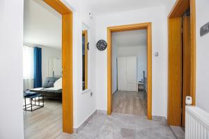 a hallway with a door open to a bedroom with a bed at Apartment Izvir Lahinje in Dragatuš