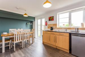 a kitchen and dining room with a table and chairs at Luke Stays - Windmill Way in Gateshead