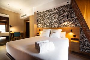a hotel room with a bed with towels on it at Hotel Atari in Donostia-San Sebastián