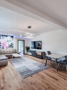 a living room with a couch and a table at Apartament VIP CENTRUM in Mrągowo