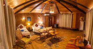 a living room with two beds and a table at Souly Ecolodge Salalah in Salalah