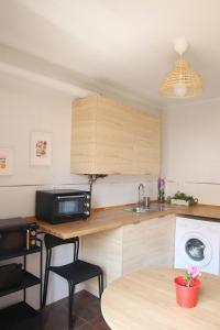 a kitchen with a table and a sink and a microwave at Casascobo 2 in Po +15 photos