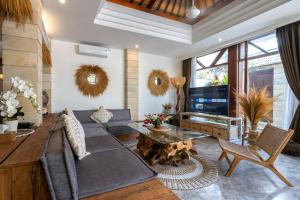 ein Wohnzimmer mit Couch und Fernseher in der Unterkunft Miracle villa Canggu in Canggu