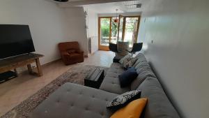 a living room with a couch and a flat screen tv at Chez Thomas in Sézanne