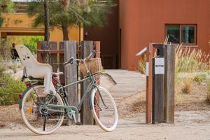a bike parked next to a wooden fence at Pestana Troia Eco-Resort & Residences in Troia