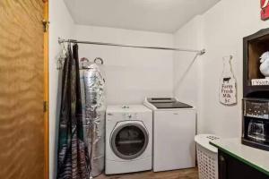 a laundry room with a washing machine and a washer at Buckner’s Getaway! Close to town, lake and river! in Bryson City