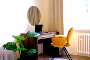a room with a desk with a laptop and a mirror at Luxury Three-Bedroom Apartment in Teplice +36 photos