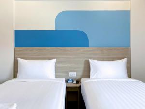 Postel nebo postele na pokoji v ubytování HOP INN Nakhon Ratchasima City Center + 16 fotografií
