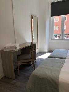 a bedroom with a desk and a bed and a window at Be Lisbon Residence Marquês in Lisbon