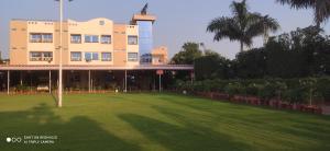 a building with a large lawn in front of it at Ruchishree Garden in Ujjain +40 photos