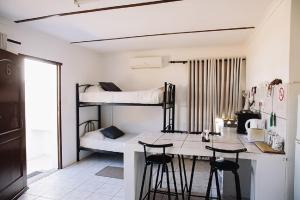 a room with two bunk beds and a counter with stools at White House Guest Farm in Grünau