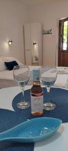 una botella de whisky y dos copas de vino en una mesa en Apartment Cattaro magico en Kotor