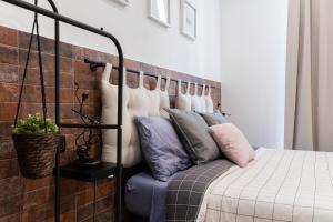 a bedroom with a bed with pillows on it at Sfumature di Puglia in Turi