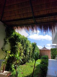a view of a patio with a straw roof at Magnifique villa El Haouaria-Nabeul in El Haouaria