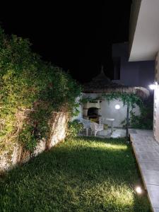 a backyard at night with a table and a grill at Magnifique villa El Haouaria-Nabeul in El Haouaria