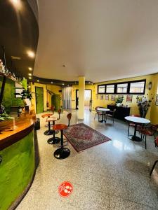 a large room with tables and chairs in a building at Hotel Motel Europa in Ossona