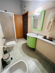 a bathroom with a toilet and a sink and a mirror at Hotel Motel Europa in Ossona +22 photos