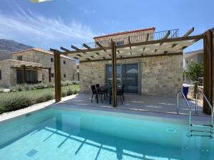 a villa with a swimming pool and a house at VILLAS BALATSOURAS in Paleros