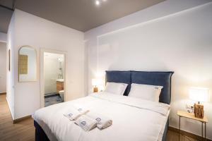 a bedroom with a bed with two towels on it at Ono Aparthotel in Mamaia Sat/Năvodari
