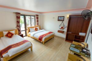 Postel nebo postele na pokoji v ubytování Minh Thanh Sa Pa Hotel