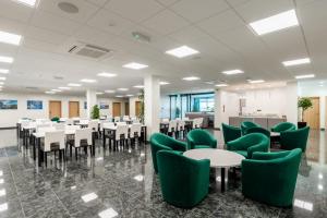 a conference room with tables and green chairs at HOSTEL GREEN in Donji Kraljevec