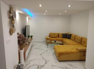 a living room with a couch and a marble floor at Apartman Meld in Vrh