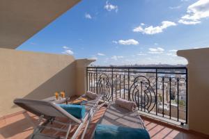 a balcony with chairs and a view of the ocean at AX The Palace in Sliema