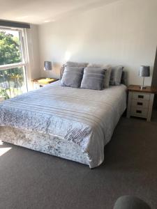 a bedroom with a large bed and a window at Very Large lovely double room loft apartment in Carlton Colville