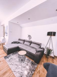 a living room with a couch and a table at Unicorn Hřensko in Hřensko +13 photos