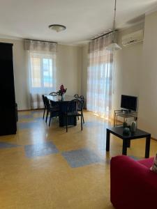 a living room with a table and a couch at Palazzina Salodium INCANTO - ARMONIA - ENERGIA in Salò