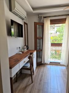 a kitchen with a wooden desk and a window at in Ephesus Hotel and Art Galery in Selcuk