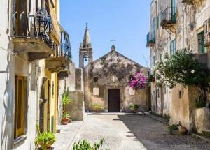 an alley in an old building with a church at Lipari Centro Storico Flat 8 min from port in Lipari