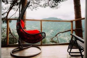 a red chair sitting on a porch with a view at Bazaletis Akvani 