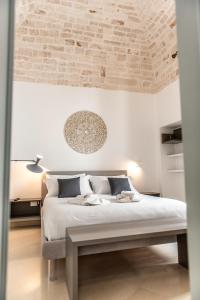 a bedroom with a bed and a brick wall at Domus San Giovanni in Locorotondo