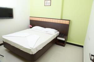 Postel nebo postele na pokoji v ubytování Jeyam Residency, Kumbakonam