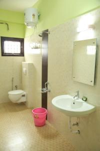 a bathroom with a sink and a toilet at Jeyam Residency, Kumbakonam in Kumbakonam