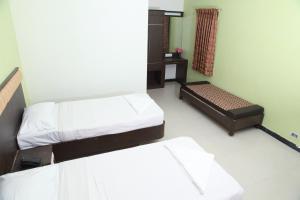 Postel nebo postele na pokoji v ubytování Jeyam Residency, Kumbakonam
