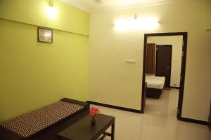 Postel nebo postele na pokoji v ubytování Jeyam Residency, Kumbakonam