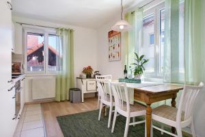a kitchen and dining room with a table and chairs at Haus Rosi in Friedrichshafen