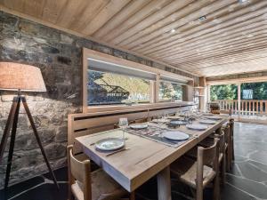 a long table in a room with a stone wall at Chalet Méribel, 5 pièces, 11 personnes - FR-1-565-46 in Les Allues