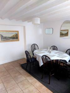 a dining room with a white table and chairs at York House in Conwy