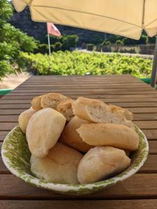 a plate of bread on a wooden table at Cala Vinagra House in Carloforte