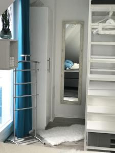 a room with a staircase and a mirror at Sonnendeck 36 - Großenbrode in Großenbrode
